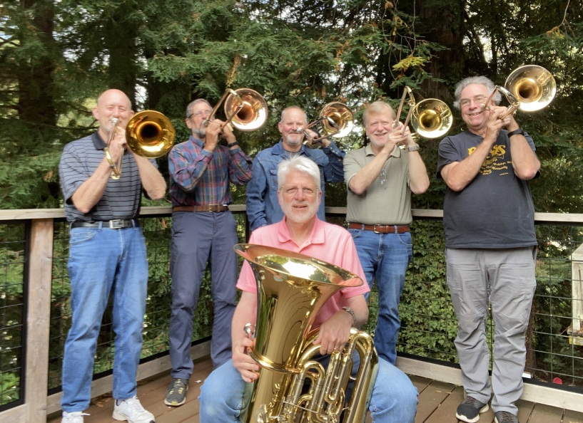 Posaunenstadt: 5 players holding trombones, stand behind 1 seated, with tuba